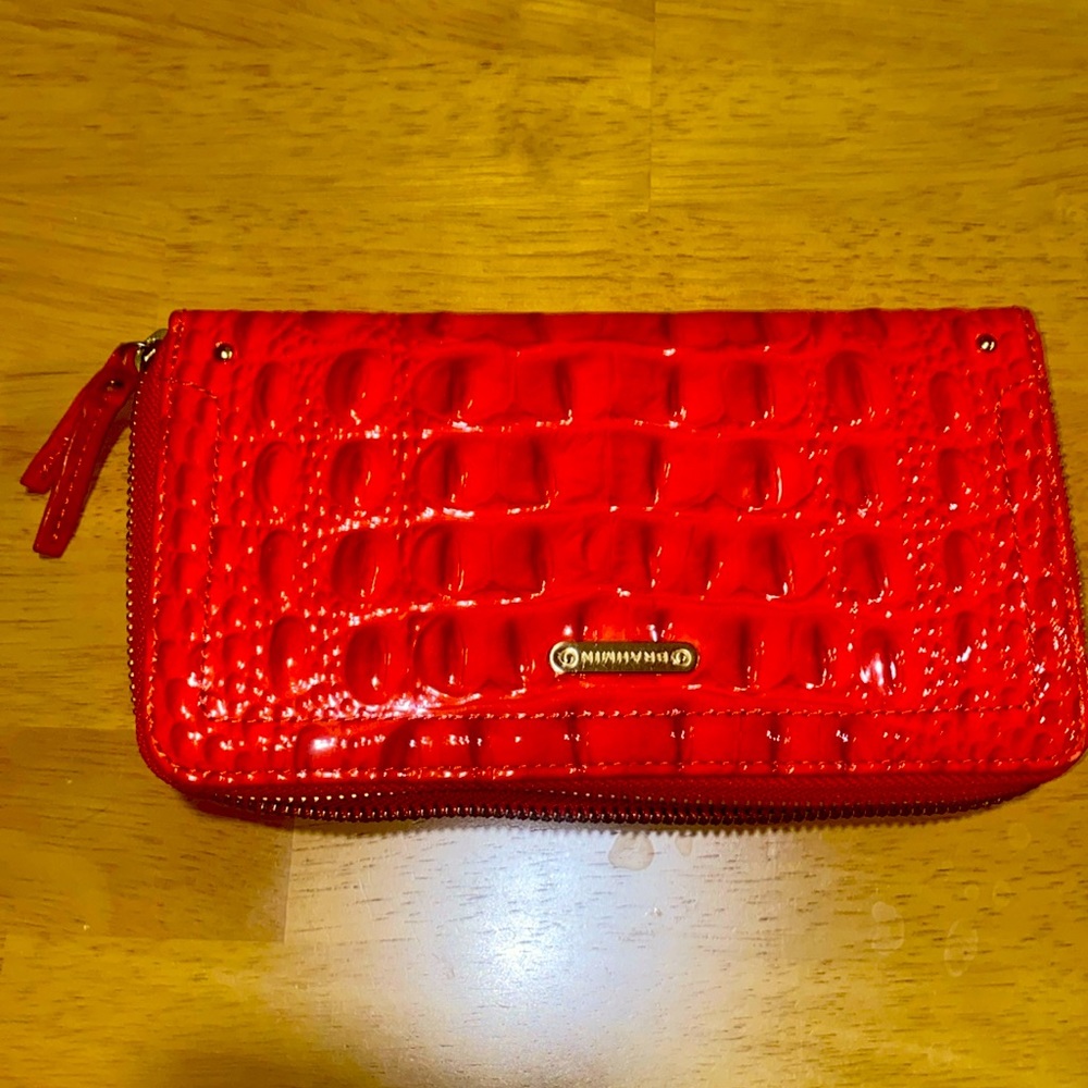 Brahmin zip around wallet. Never carried. Has the care card with serial number.